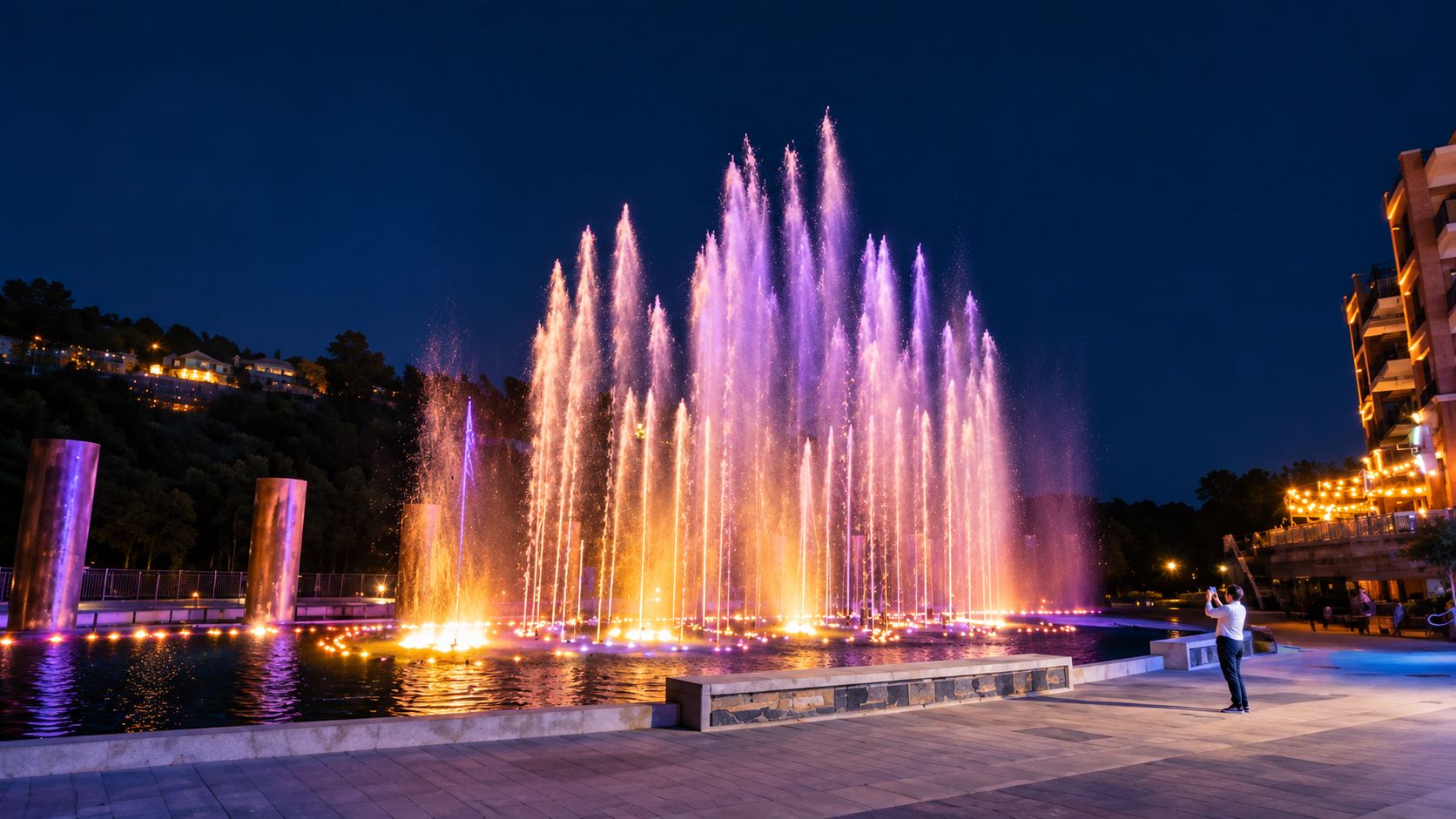 The illuminated fountains at Branson Landing after dark