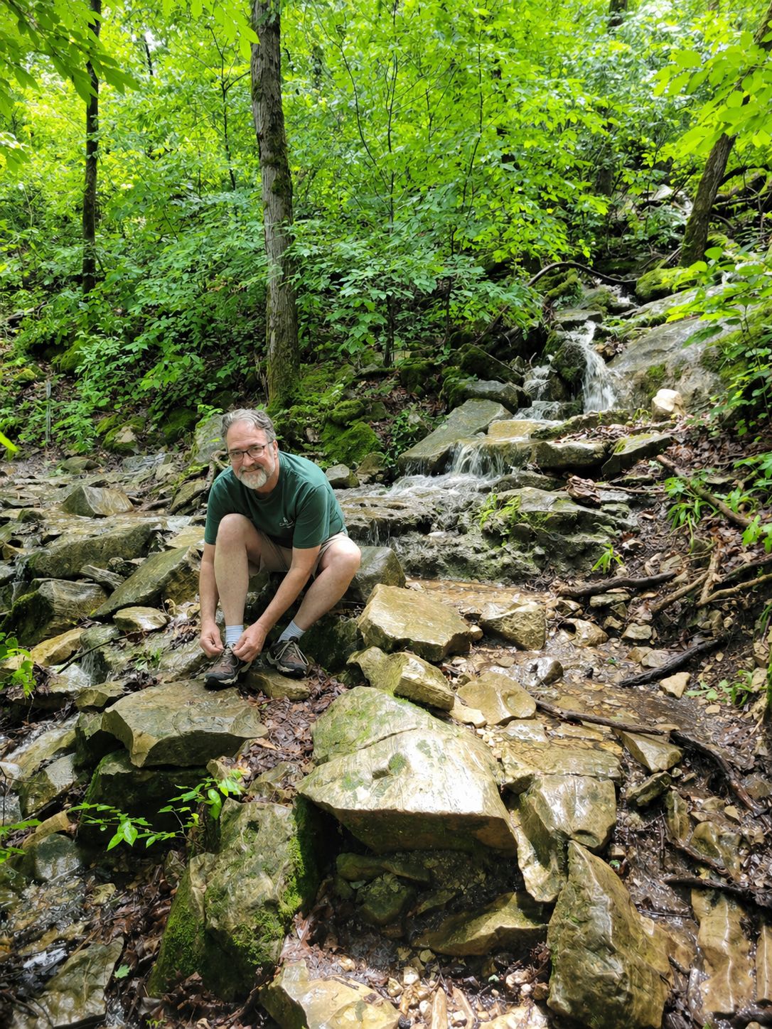 A hiker tying shoes before walking an Ozark trail near Branson Missouri