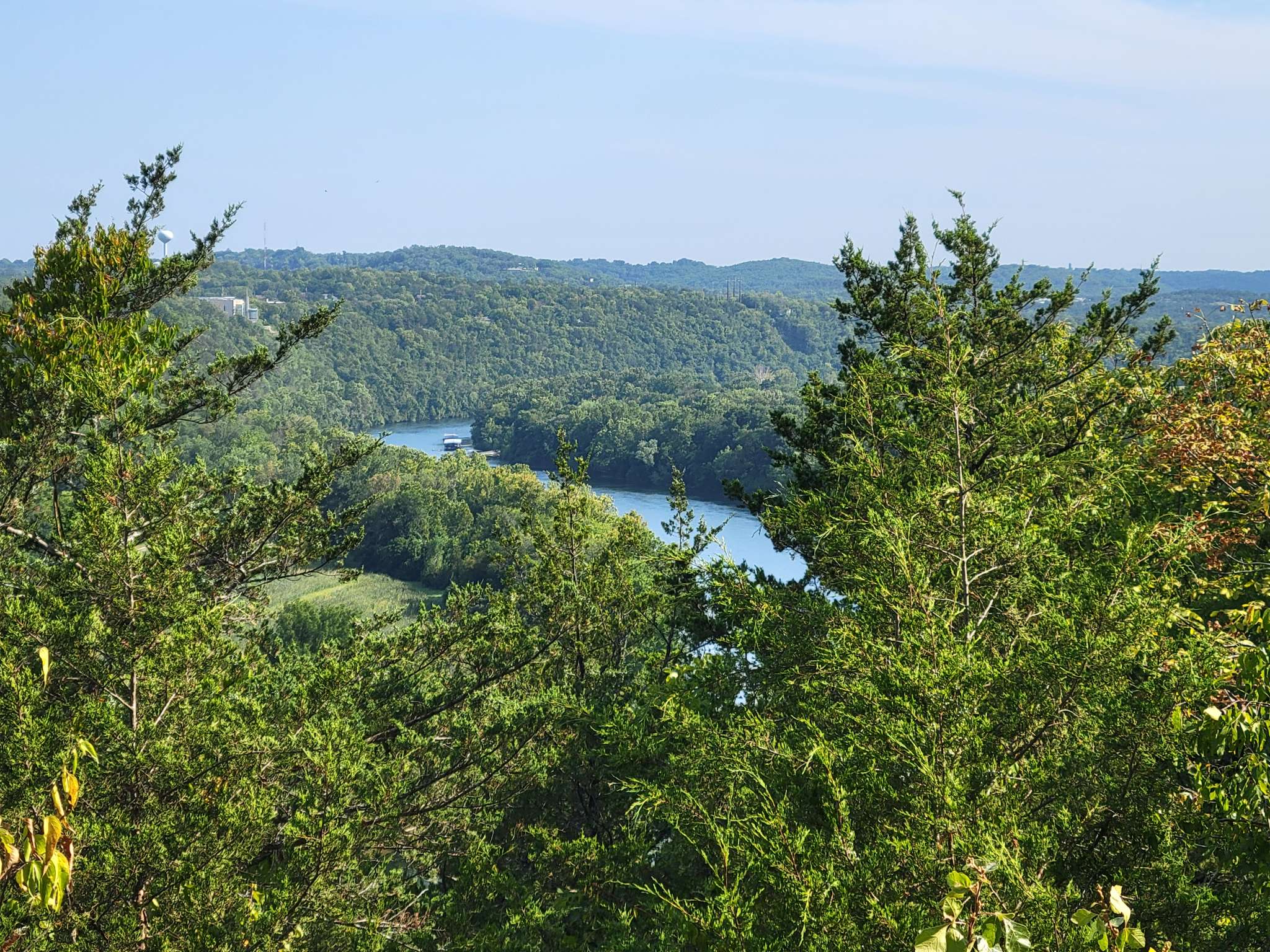 A scenic Ozark hiking trail near Branson Missouri with wooded hills and lake views